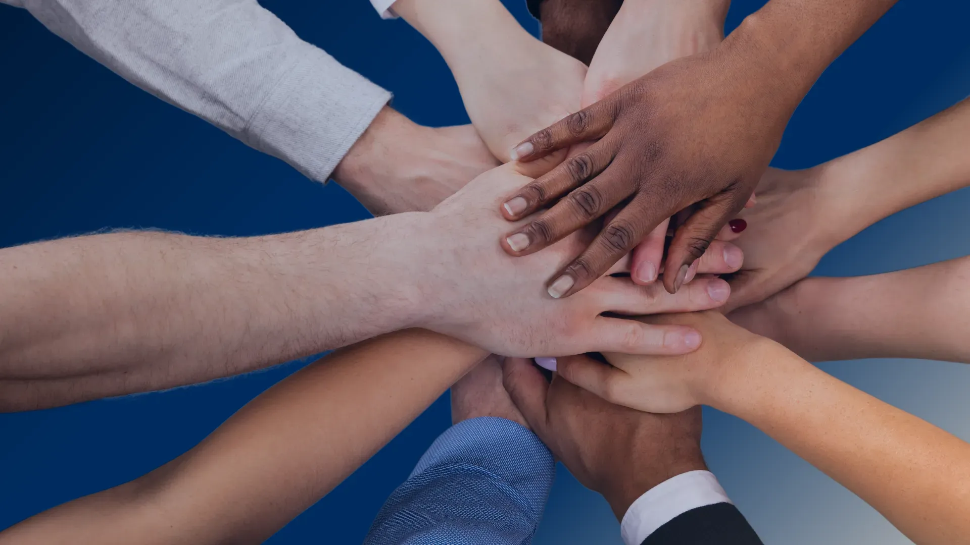 People with their hands together showing unity and support